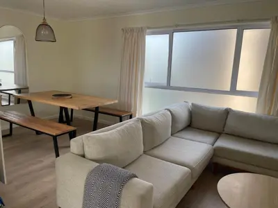 a living room with a couch and a table at Silver Sunsets Self-Catering Apartments in Cape Town