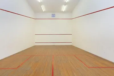 an empty room with white walls and a wooden floor at Villa Kyma in Gordonʼs Bay