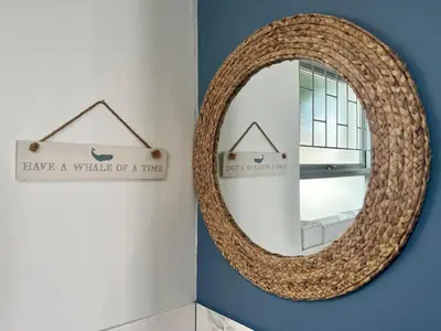a mirror with a sign that reads have a whale of a time at Adorable 2 Bedroom Cottage with spacious veranda in Hermanus