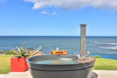 a hot tub in front of the ocean at Jock's View in Bettyʼs Bay