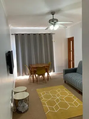 a living room with a couch and a table at Johan-nest in Cape Town
