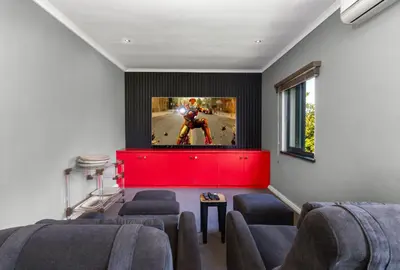 a living room with a flat screen tv on a wall at Luxury Stellenbosch Villa in Stellenbosch