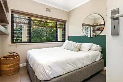 a bedroom with a large bed and a mirror at Luxury Stellenbosch Villa in Stellenbosch