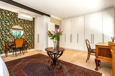 a living room with a table and a piano at Luxury Stellenbosch Villa in Stellenbosch