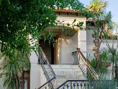 a building with stairs leading up to a door at Dawn Mountains Farm in Simondium
