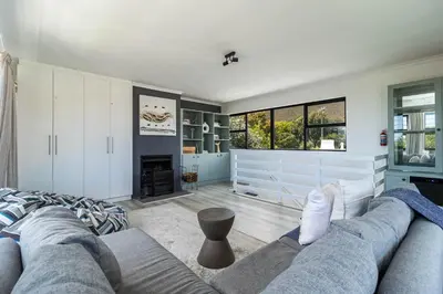 a living room with a couch and a fireplace at SAM's - Sea And Mountain in Hermanus