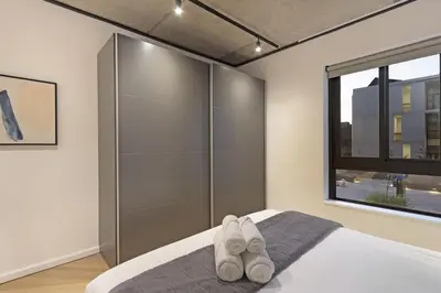 a bedroom with a bed with white towels on it at Bridgewater View 415 in Cape Town