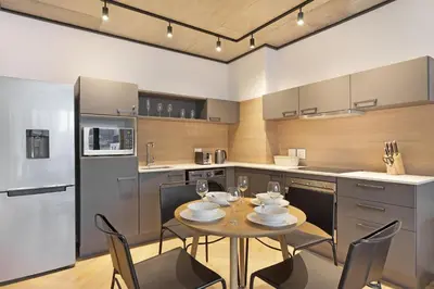 a kitchen with a table with wine glasses on it at Bridgewater View 415 in Cape Town