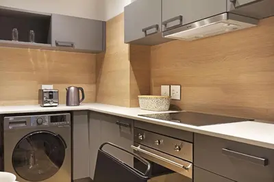 a kitchen with a dishwasher and a washer and dryer at Bridgewater View 415 in Cape Town