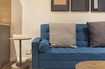 a blue couch in a living room with a table at Bridgewater View 415 in Cape Town