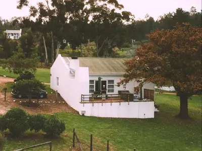 an aerial view of a white house at Ou Meul Farm Cottage in Botrivier