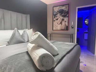 a bedroom with a bed with towels on it at Exclusive Ultra-Luxury A Cut Above Apartments Century City by Vvip Bookings in Cape Town