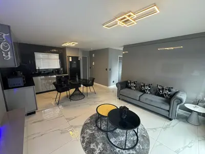 a living room with a couch and a table at Exclusive Ultra-Luxury A Cut Above Apartments Century City by Vvip Bookings in Cape Town