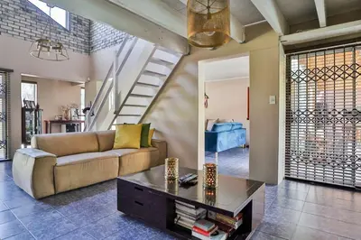 a living room with a couch and a table at Fairview Crescent by CTHA in Cape Town