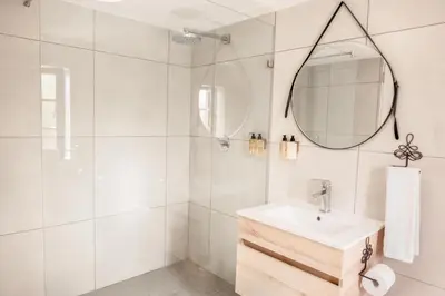 a white bathroom with a sink and a shower at Avemore Rare Gem with full Backup Power in Stellenbosch