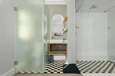 a bathroom with a sink and a mirror at Luxury Winetram getaway in Franschhoek