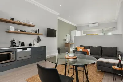 a living room with a glass table and a couch at Luxury Winetram getaway in Franschhoek