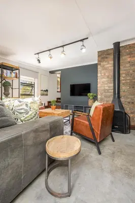 a living room with a couch and a fireplace at Avemore Time Out - full power back up in Stellenbosch