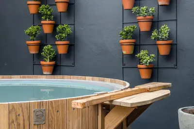 a hot tub with potted plants on a wall at Avemore Time Out - full power back up in Stellenbosch