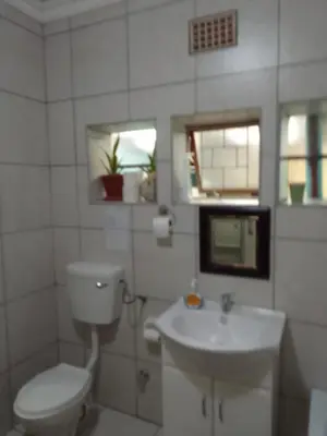a white bathroom with a toilet and a sink at LRN Brackenfell Homestay in Cape Town
