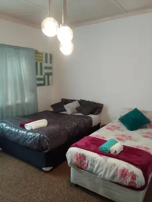 a bedroom with two beds in a room at LRN Brackenfell Homestay in Cape Town