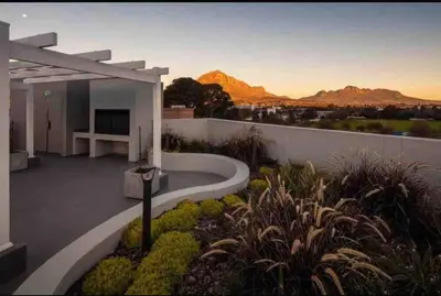 a balcony of a house with a view of the mountains at Modern Apartment in Stellenbosch in Stellenbosch