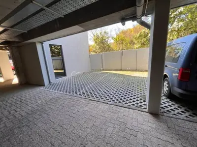 an empty garage with a car parked in it at Modern Apartment in Stellenbosch in Stellenbosch