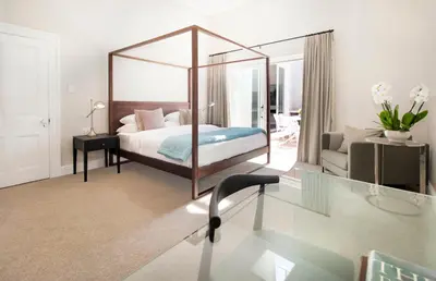 a bedroom with a bed with a large mirror at Middedorp Manor in Stellenbosch