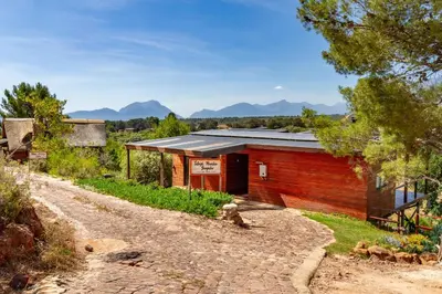 a small red brick building on a dirt road at Tulbagh Mountain Bungalow in Wolseley