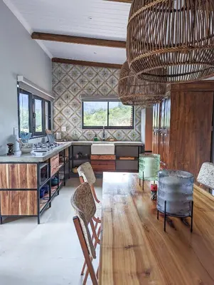 a kitchen with a table and a large chandelier at Tulbagh Mountain Bungalow in Wolseley