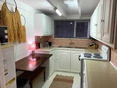 a small kitchen with white cabinets and a stove at Prometheus in Lake Marina
