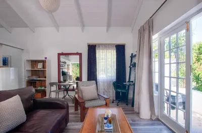 a living room with a couch and a table at The Earthy Inn in Greyton