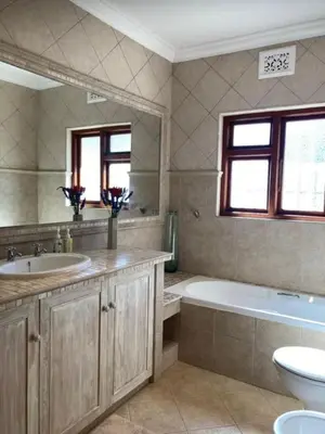 a bathroom with a tub and a toilet and a sink at Goldeneye Private Venue Spectre in Raithby