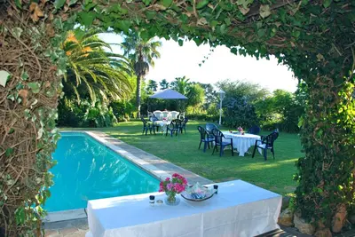 an archway with a table and chairs next to a pool at Goldeneye Private Venue Spectre in Raithby