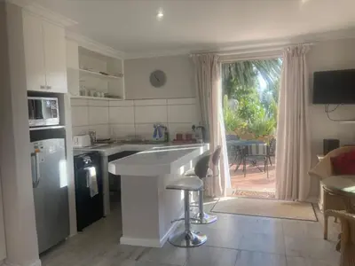 a kitchen with a counter and a refrigerator and a table at Goldeneye Private Venue Spectre in Raithby