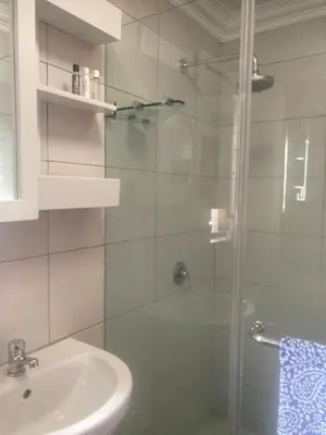 a bathroom with a glass shower with a sink at Goldeneye Private Venue Spectre in Raithby