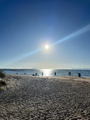 a group of people on a beach near the water at Beachside Bliss Strand in Strand