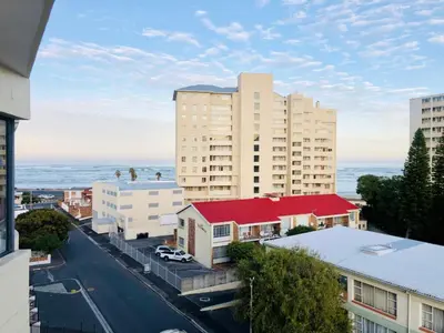 an aerial view of a city with buildings and the ocean at Beachside Bliss Strand in Strand