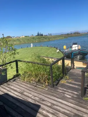 a dock with a boat on the water at Nature's Rest in Cape Town