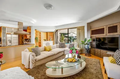 a living room with a couch and a table at Erinvale Luxury Villa in Cape Town