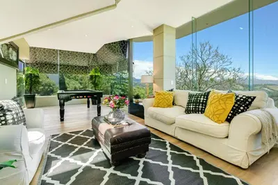a living room with a white couch and a table at Erinvale Luxury Villa in Cape Town
