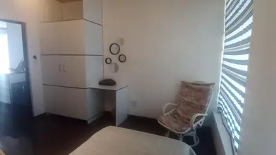a bedroom with a bed and a desk and a chair at Whalers Retreat in Bettyʼs Bay