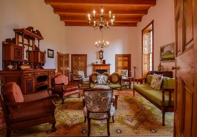 a living room filled with furniture and a chandelier at Heins Manor House in Stellenbosch