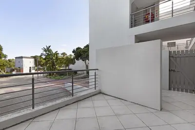a balcony of a house with a fence at Waterstone East C103 by Host Agents in Cape Town