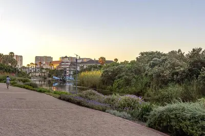 a person walking along a path next to a river at Waterstone East C103 by Host Agents in Cape Town