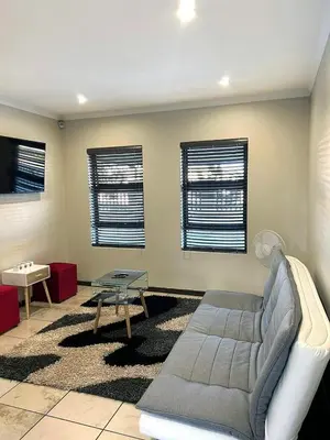 a living room with a couch and a table at 81 on Groenewoud in Cape Town