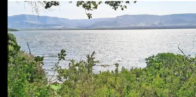 a large body of water with mountains in the background at Milkwood Cabin Getaway in Lake Marina