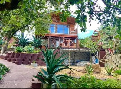 a house with a lot of plants in front of it at Milkwood Cabin Getaway in Lake Marina