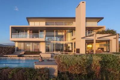 a large house with a pool in front of it at Benguela Cove - Oceans Away in Hermanus