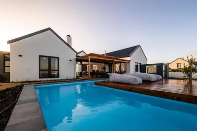 a swimming pool in the backyard of a house at Benguela Cove - Utopia in Hermanus